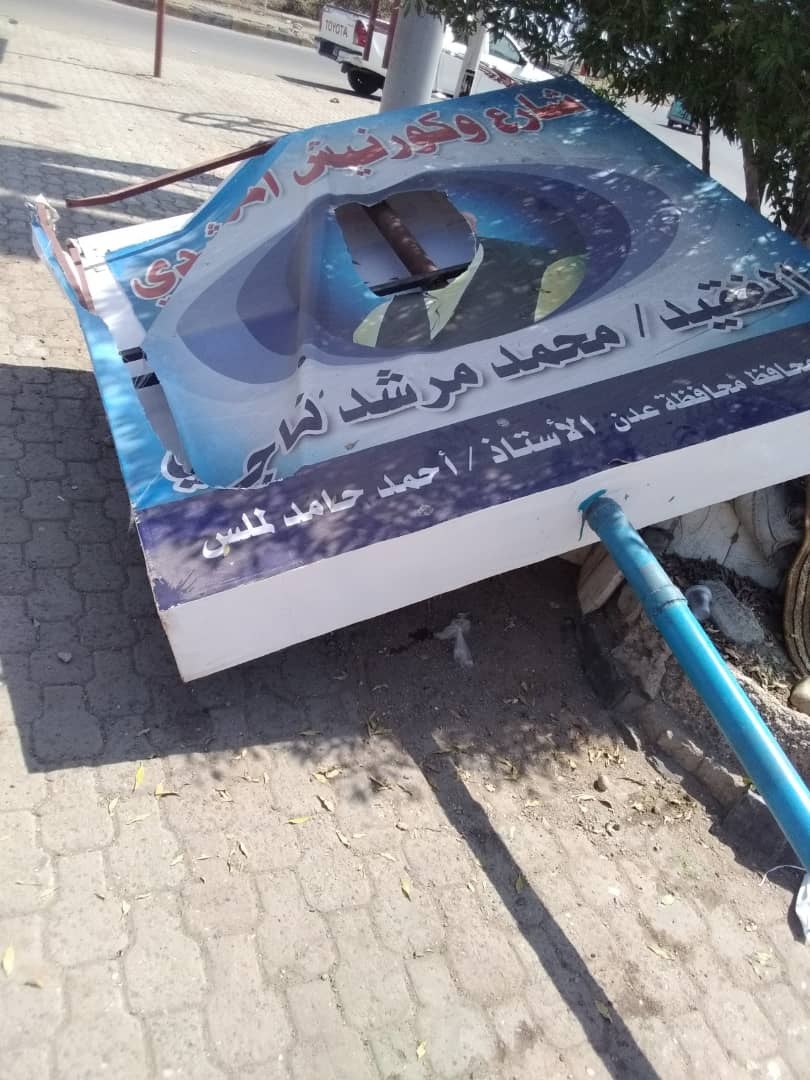 قائد في الحزام الأمني يعتدي بالتخريب والازالة على لوحة شارع وكورنيش المرشدي (صور)