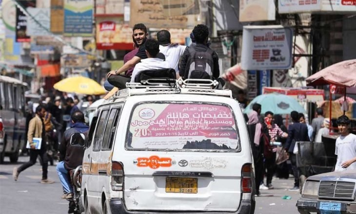 اليمنيون يلجأون إلى إعتلاء أسطح سيارات الأجرة أو التعلق على جوانبها بسبب نقص الوقود